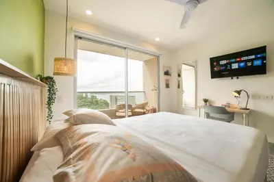 a bedroom with a large bed and a large window at Loft Premium con Vista al Mar in Santa Marta
