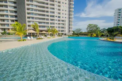 a swimming pool with blue water in front of a building at Loft Premium con Vista al Mar in Santa Marta