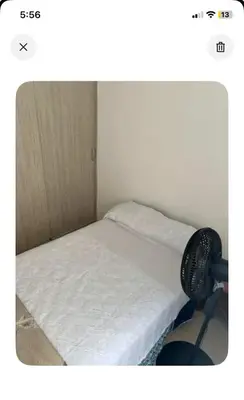 a bedroom with a bed with a fan next to it at Modern and renowned apartment in Cartagena in Cartagena de Indias
