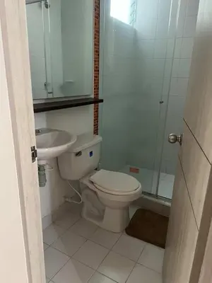 a white bathroom with a toilet and a sink at Modern and renowned apartment in Cartagena in Cartagena de Indias