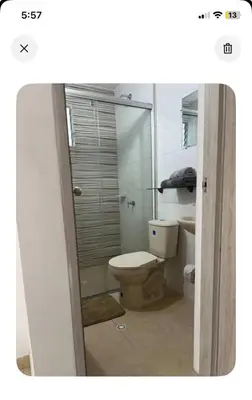 a bathroom with a toilet and a glass shower at Modern and renowned apartment in Cartagena in Cartagena de Indias