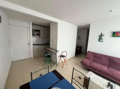 a living room with a purple couch and a table at Modern and renowned apartment in Cartagena in Cartagena de Indias