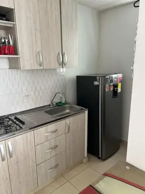 a kitchen with a black refrigerator and a sink at Modern and renowned apartment in Cartagena in Cartagena de Indias