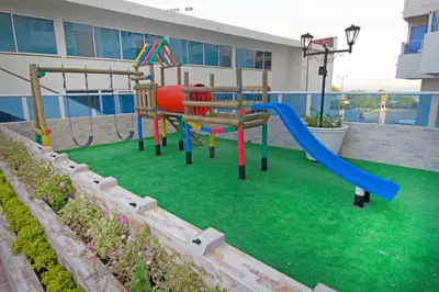 a playground with a slide on a lawn at Apartamento con vista al mar - Riviera Mulata Beach in Cartagena de Indias