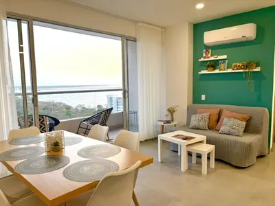 a living room with a table and a couch at Horizonte Infinito - Calidez frente al mar Santa Marta in Santa Marta