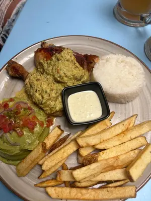 a plate of food with french fries and dipping sauce at Horizonte Infinito - Calidez frente al mar Santa Marta in Santa Marta