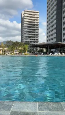 a pool of water in front of two tall buildings at Horizonte Infinito - Calidez frente al mar Santa Marta in Santa Marta