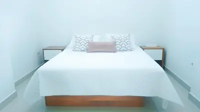 a bedroom with a bed with a white bedspread at Magico Apartamento Frente al Mar 3 Habitaciones BM81 in Coveñas