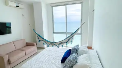 a bedroom with a hammock in front of a window at Magico Apartamento Frente al Mar 3 Habitaciones BM81 in Coveñas
