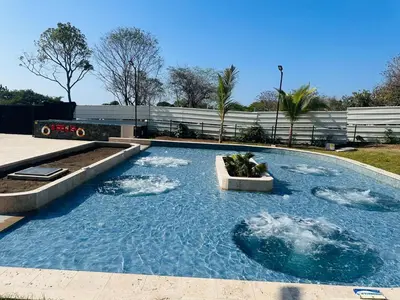 a swimming pool with three rocks in the water at New apartment on the 18th floor in Santa Marta with ocean views in Simón Bolivar