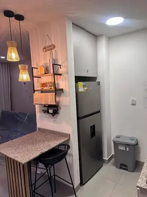 a kitchen with a counter and a refrigerator at New apartment on the 18th floor in Santa Marta with ocean views in Simón Bolivar