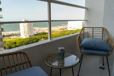 a balcony with two chairs and a table with a view at Ocean Blue Apartment WiFI Beach Old Town in Cartagena de Indias
