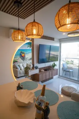 a living room with a couch and a tv at Ocean Blue Apartment WiFI Beach Old Town in Cartagena de Indias