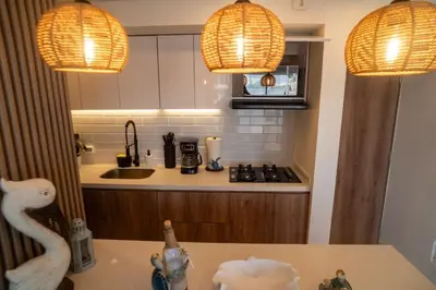 a kitchen with two lights and a counter with a sink at Ocean Blue Apartment WiFI Beach Old Town in Cartagena de Indias