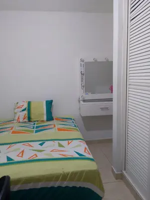 a bedroom with a bed and a tv on a wall at Apartamento amoblado in Barranquilla