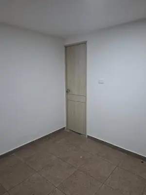 an empty room with a door and a tile floor at Apartamento amoblado in Barranquilla