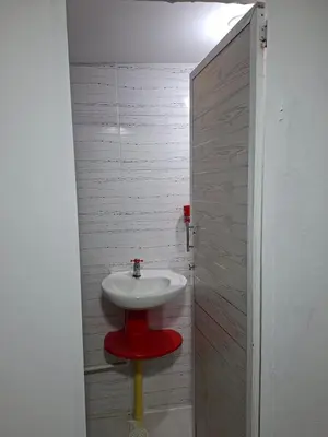 a bathroom with a red sink in a room at Apartamento amoblado in Barranquilla