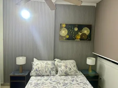 a bedroom with a bed and two night stands with lamps at Apartamento Sol y mar Cartagena in Cartagena de Indias