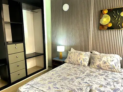 a bedroom with a bed and a dresser and a mirror at Apartamento Sol y mar Cartagena in Cartagena de Indias