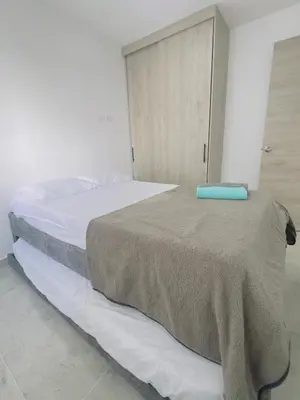 a bedroom with a bed with a brown blanket on it at Beach 1203 Lotus Cartagena in Cartagena de Indias