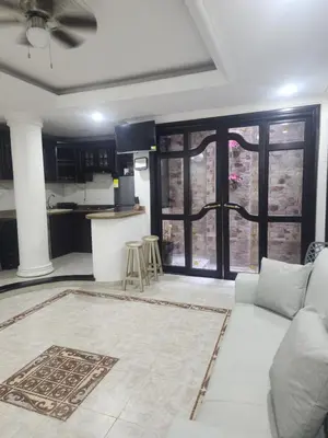 a living room with a couch and a kitchen at Capri apartamento in Guayepo