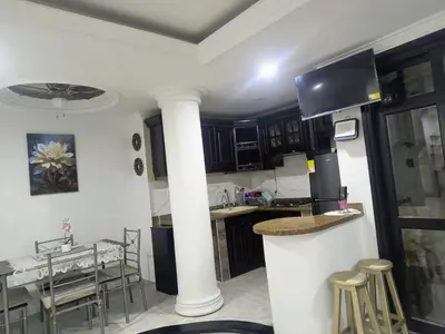 a kitchen with a column and a table with chairs at Capri apartamento in Guayepo