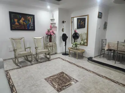 a living room with two chairs and a table at Capri apartamento in Guayepo