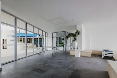 a living room with a table and a glass wall at Ocean View Loft Altamar in Cartagena de Indias