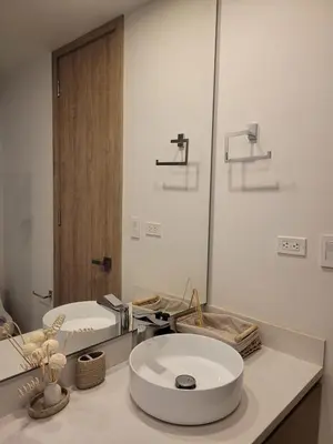 a white bathroom with a sink and a mirror at Apartamento in Morros Eos-Manzanillo del Mar in Cartagena de Indias