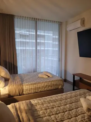 a hotel room with two beds and a window at Apartamento in Morros Eos-Manzanillo del Mar in Cartagena de Indias