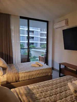 a hotel room with two beds and a large window at Apartamento in Morros Eos-Manzanillo del Mar in Cartagena de Indias