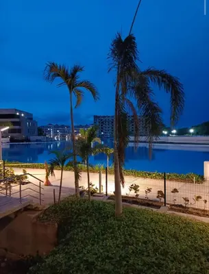 a view of the water and palm trees at night at Baía Kristal Spectacular View Crystal Clear Lagoon in Cartagena de Indias