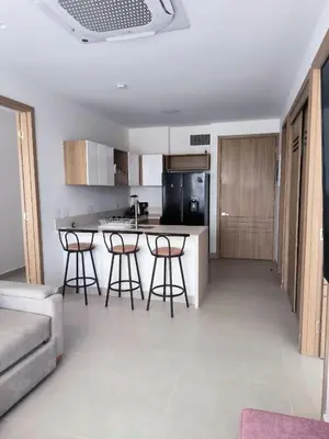 a kitchen with a table and stools in a room at Baía Kristal Spectacular View Crystal Clear Lagoon in Cartagena de Indias