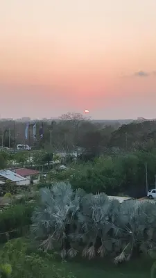 a sunset over a parking lot with palm trees at Baía Kristal Spectacular View Crystal Clear Lagoon in Cartagena de Indias