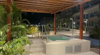 a hot tub on a patio with a building at Baía Kristal Spectacular View Crystal Clear Lagoon in Cartagena de Indias