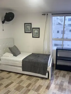 a bedroom with a bed and a large window at Marea Laguito Apartamentos Cartagena in Cartagena de Indias