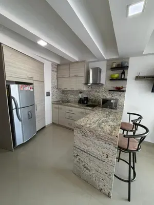 a kitchen with a counter and a refrigerator at Lujoso Apartamento en Cartagena in Cartagena de Indias