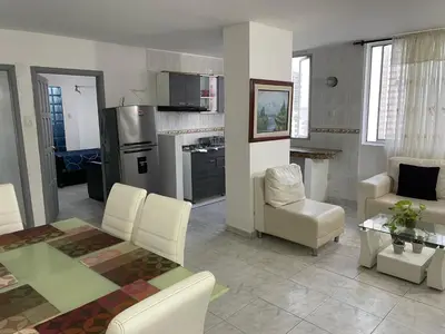 a kitchen and living room with a table and chairs at Delfines De Bocagrande in Cartagena de Indias