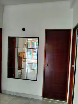 a mirror on a wall next to a wooden door at Sandymar in San Bernardo del Viento