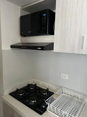 a microwave oven above a stove in a kitchen at Spacious Flat with stunning Views Great Location in Cartagena de Indias