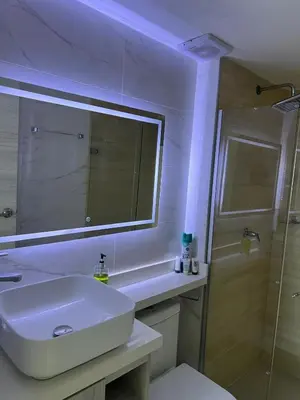 a white bathroom with a sink and a shower at Spacious Flat with stunning Views Great Location in Cartagena de Indias