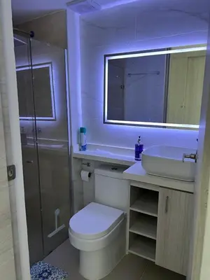 a bathroom with a toilet and a sink and a mirror at Spacious Flat with stunning Views Great Location in Cartagena de Indias