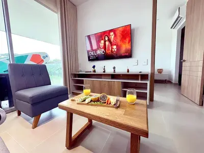 a living room with a table and a tv at Exclusivo Apartamento en Cartagena, Baia Kristal, Zona Kabo in Cartagena de Indias