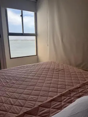 a bedroom with a large bed and a window at Apto en Edificio Centauro Ideal para tu estadia in Cartagena de Indias