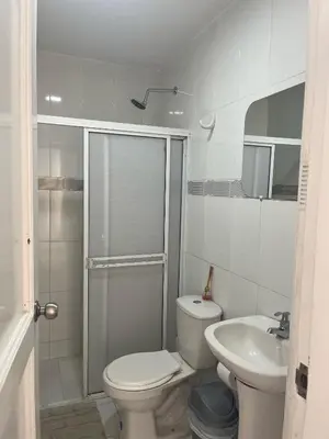 a white bathroom with a toilet and a sink at Apto en Edificio Centauro Ideal para tu estadia in Cartagena de Indias