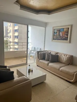 a living room with a couch and a coffee table at Apto en Edificio Centauro Ideal para tu estadia in Cartagena de Indias