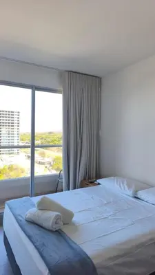 a bedroom with a large bed with a large window at Santa Marina Caribbean Dreams in Santa Marta