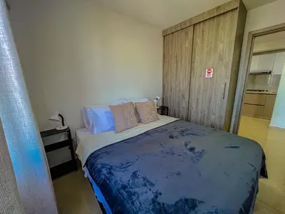 a bedroom with a bed with blue sheets and pillows at View 17, Modern, 5 min from Rafael Nuñez Airport in Cartagena de Indias