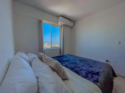a bedroom with a large bed and a window at View 17, Modern, 5 min from Rafael Nuñez Airport in Cartagena de Indias