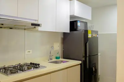 a kitchen with a stainless steel refrigerator and a sink at View 17, Modern, 5 min from Rafael Nuñez Airport in Cartagena de Indias